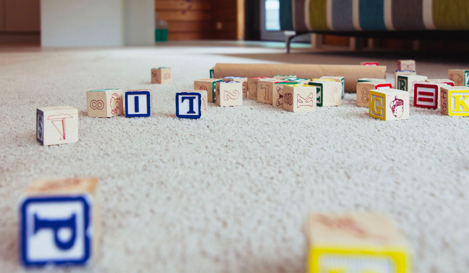 Photo of a twist pile carpet with childs blocks stacked on it