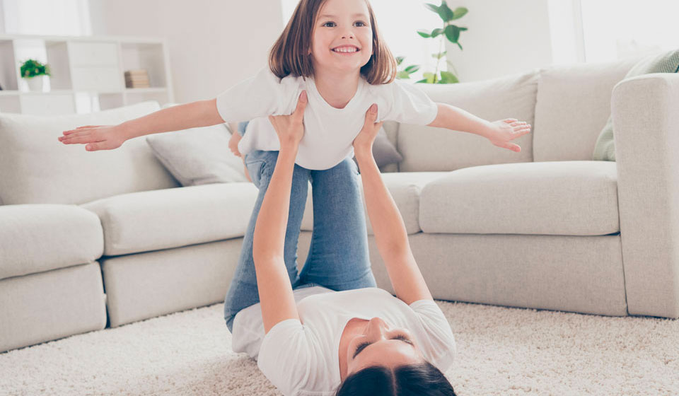 Mum and daughter playing on a comfy carpet