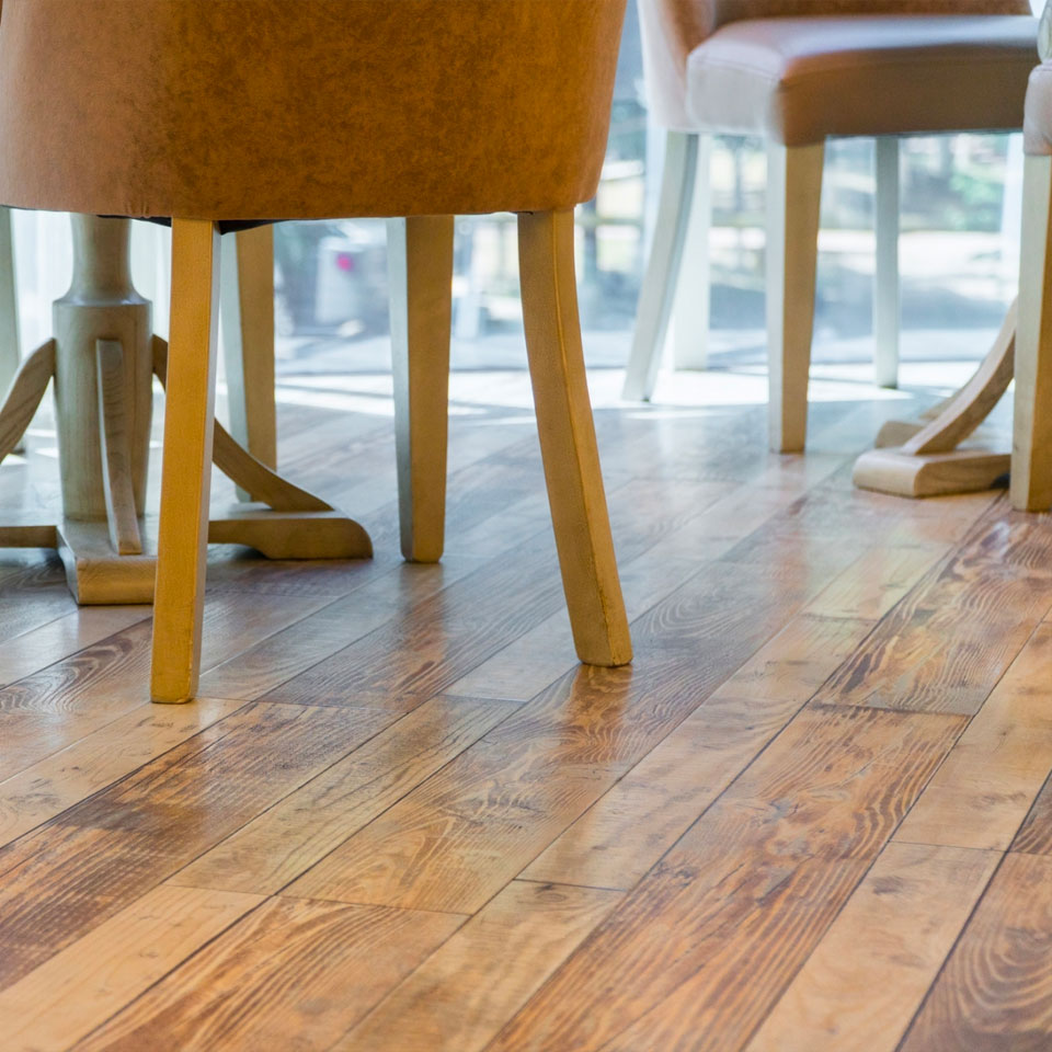 Photo of wood laminate flooring with chairs on it