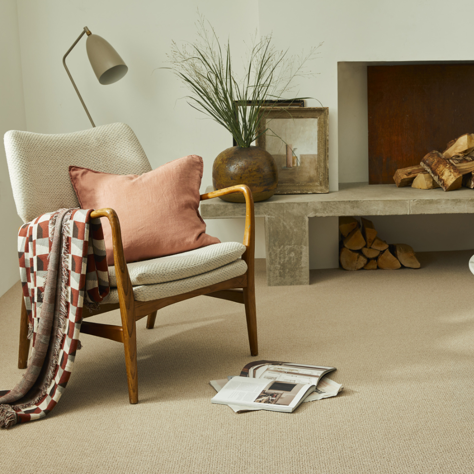 Mainland loop berber loop carpet in a minimal stylish lounge with fireplace and comfy armchair